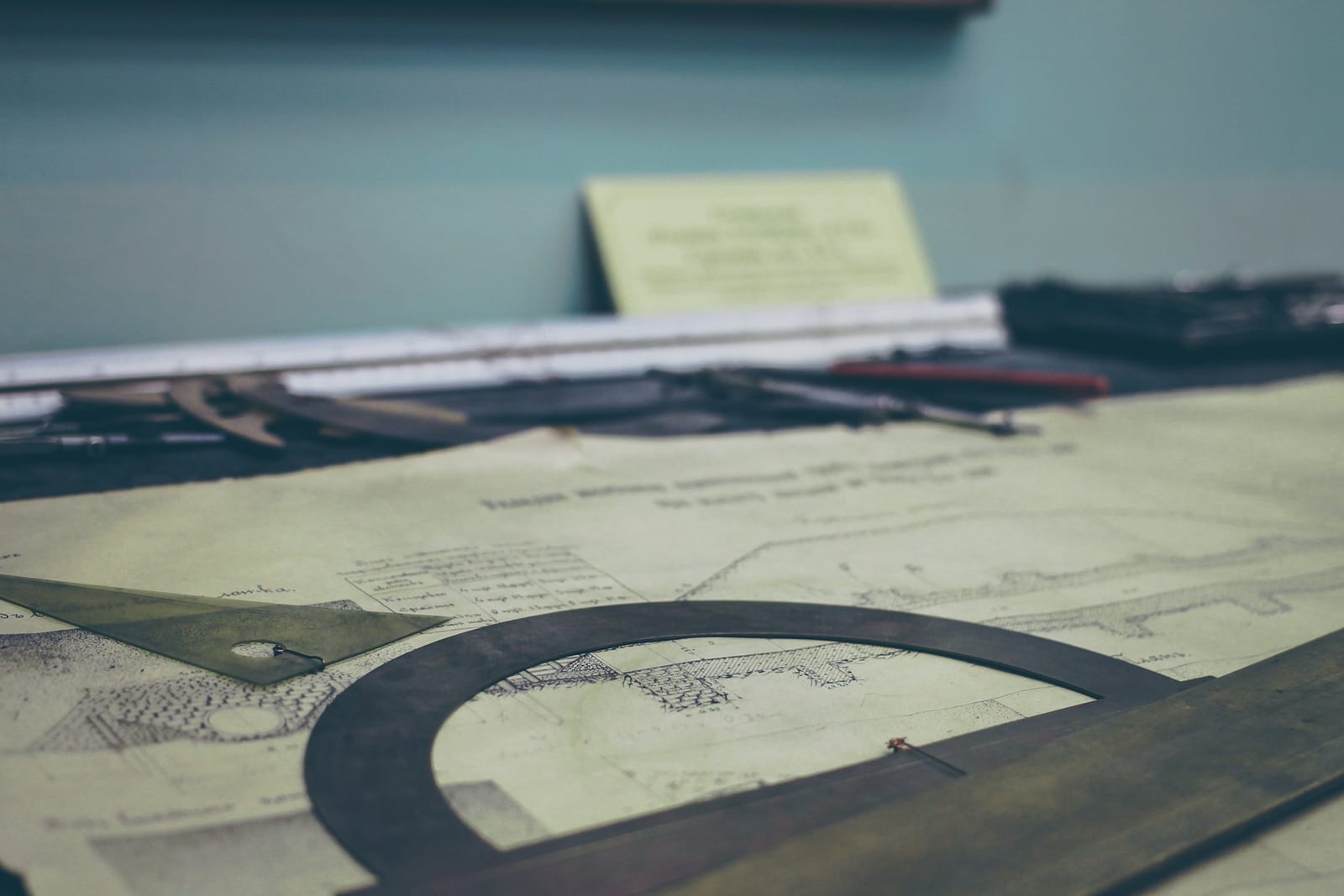 Structural beam design drawings spread on a working desk — engineering project review.